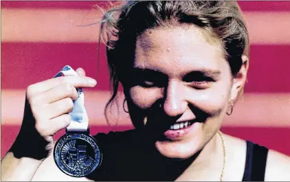  ?? SUBMITTED PHOTO ?? Tracey Hussey holds her silver medal after the 5,000-metre race walk at the 1997 Canada Games in Brandon, Man.