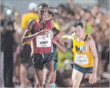  ?? FRANK GUNN THE CANADIAN PRESS ?? Mohammed Ahmed wins the men’s 5,000-metre race at the Canadian track and field championsh­ips in Ottawa on Thursday. Kitchener’s Ben Flanagan, in the yellow shirt, finished third.