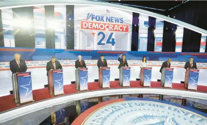  ?? MORRY GASH/AP ?? Republican presidenti­al candidates, from left, former Arkansas Gov. Asa Hutchinson, former New Jersey Gov. Chris Christie, former Vice President Mike Pence, Florida Gov. Ron DeSantis, businessma­n Vivek Ramaswamy, former U.N. Ambassador Nikki Haley, Sen. Tim Scott, R-S.C., and North Dakota Gov. Doug Burgum stand on stage before a Republican presidenti­al primary debate Aug. 23 in Milwaukee.