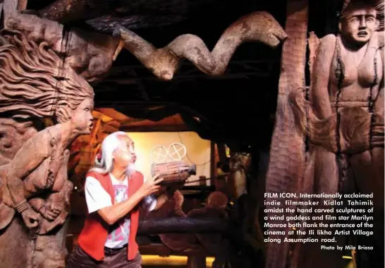  ?? Photo by Milo Brioso ?? FILM ICON. Internatio­nally acclaimed indie filmmaker Kidlat Tahimik amidst the hand carved sculptures of a wind goddess and film star Marilyn Monroe both flank the entrance of the cinema at the Ili likha Artist Village along Assumption road.