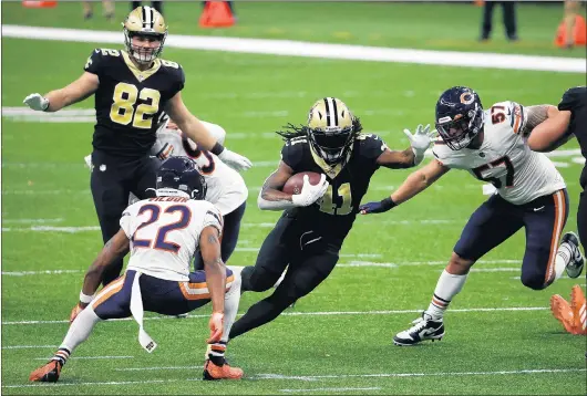  ?? PHOTOS BY CHRIS GRAYTHEN/GETTY ?? New Orleans Saints running back Alvin Kamara runs the ball against Kindle Vildor(22 ) of the Chicago Bears during the fourth quarter in the NFC Wild Card game