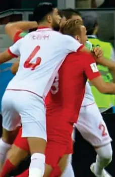  ??  ?? Hands on: England captain Harry Kane is wrestled to the ground by Yassine Meriah in the 51st minute