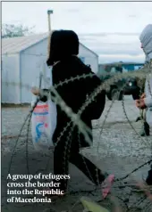  ??  ?? A group of refugees cross the border into the Republic of Macedonia