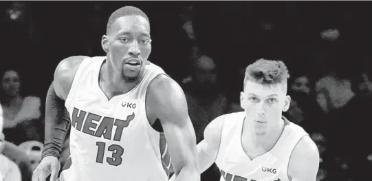  ?? JOHN MINCHILLO / AP ?? Bam Adebayo, left, and Tyler Herro are Heat teammates now and could be Olympic teammates down the road.