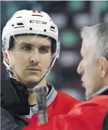  ?? CHRISTINA RYAN/ CALGARY HERALD ?? Struggling centre Mikael Backlund gets some input from coach Bob Hartley during practice on Monday. Backlund has just one goal in 12 games to start the season.