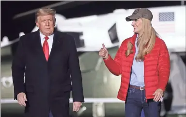  ?? Alex Wong/Getty Images North America/TNS ?? U.S. President Donald Trump arrives with Sen. Kelly Loeffler (R-Ga.) at a campaign rally at Dalton Regional Airport Monday in Dalton. Trump campaigned for Loeffler and Sen. David Perdue (R-Ga.) ahead the Jan.5 run-off elections in Georgia.