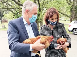  ??  ?? Leader the Nationals and Shadow Agricultur­e Minister Peter Walsh holds “Parma” alongside Nationals Member for Eastern Victoria Melina Bath with “Cluck Norris”. of