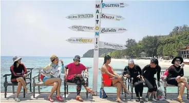  ?? /Reuters ?? Fun in the sun: Tourists wait for their boat at Maiton Island in Phuket, Thailand, in 2016. With its palm-fringed beaches, Buddhist culture and racy nightlife, Thailand has been the poster child for Asian tourism for decades. It is now targeting gay...