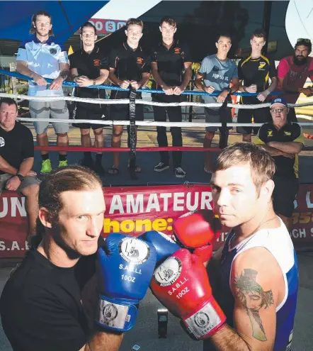  ?? LET’S GET IT ON: Mt Low’s Mark Snook and Daniel Mulhall of Aitkenvale square up. Picture: SCOTT RADFORD- CHISHOLM ??