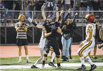  ?? DENIS POROY ?? Carlsbad’s Josh Davis celebrates after catching the game-winning touchdown pass against Torrey Pines.