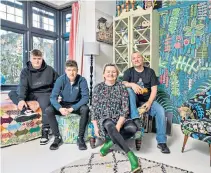  ??  ?? ▲ Lucy Tiffney with her husband and sons in their vibrant home, which shows off some of Tiffney’s flamboyant wallpaper designs