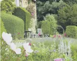  ?? ?? BEAUTIFUL: The garden has seating areas, an impressive stone pergola, cobbled pathways and extensive yew topiary.