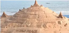  ??  ?? The world’s tallest sand castle made by Sudarsan on Puri beach