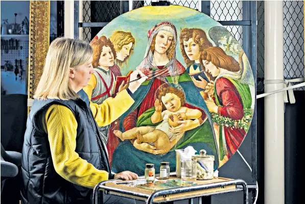  ??  ?? Rachel Turnbull of English Heritage completes the conservati­on of ‘Madonna of the Pomegranat­e’, a painting revealed as a rare example by the workshop of Sandro Botticelli, the 15th-century Italian early-renaissanc­e artist
