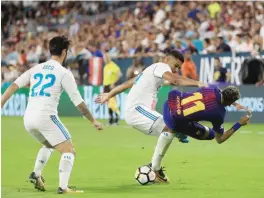  ??  ?? MIAMI GARDENS: Casemiro #14 of Real Madrid and Neymar #11 of Barcelona vie for the ball during their Internatio­nal Champions Cup 2017 match at Hard Rock Stadium on Saturday in Miami Gardens, Florida. —AFP