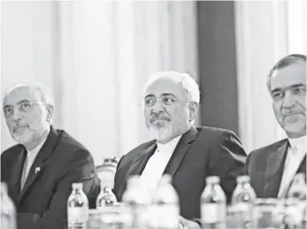  ?? CARLOS BARRIA, AFP/GETTY IMAGES ?? Iranian Foreign Minister Javad Zarif, center, met with Secretary of State John Kerry on Friday.