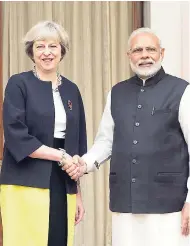  ??  ?? Indian Prime Minister Narendra Modi shakes hand with his British counterpar­t, Theresa May, before a meeting in New Delhi, India, on Monday, November 7.