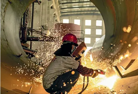  ?? GETTY IMAGES ?? A welder works in a workshop of an equipment manufactur­ing enterprise to produce large building materials equipment for export to countries along the ‘‘One Belt And One Road’’ route, in Hai ’an, east China’s Jiangsu Province.