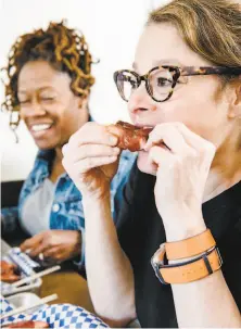  ?? Michael Short / Special to The Chronicle ?? Julie Katz (right) and her friend Larene Paré enjoy the barbecue at KC’s, which will go to mediation with neighbors.