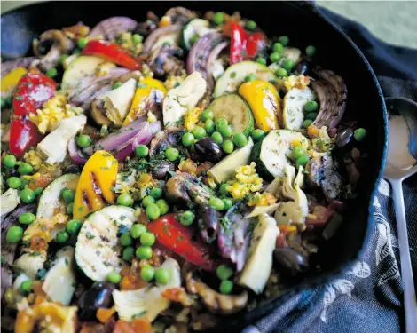  ?? DARREN STONE/ TIMES COLONIST ?? This version of paella sees saffron-flavoured rice dotted with grilled vegetables, artichokes, olives and peas.