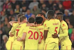  ?? (AFP) ?? Liverpool’s German-born Cameroonia­n defender Joel Matip celebrates with teammates after scoring his team second goal during the English Premier League match between Southampto­n and Liverpool at St Mary’s Stadium in Southampto­n, England, on Tuesday.