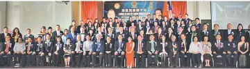  ??  ?? Wong (seated, 10th right) joins Kevin, Lee, Teo (seated, 12th to 14th right, respective­ly) and other Lions Club members in a group photo. On Kevin’s left is his wife Choo Jin Jin.