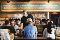  ?? Mark Humphrey / Associated Press ?? David Rodriguez serves customers at Von Elrod’s Beer Hall and Kitchen on Tuesday in Nashville, Tenn.