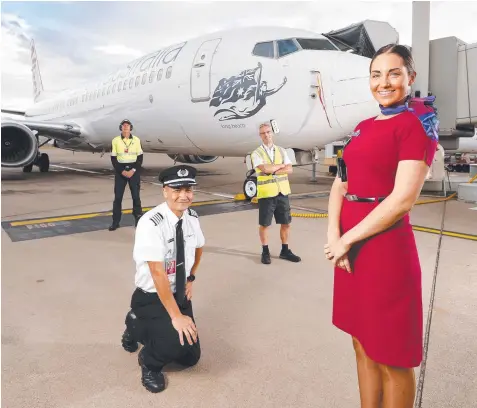  ?? Picture: JOSH WONING ?? Virgin staff Phil Vlieg, Captain Anthony Saville, Peter Armstrong and Alahna Wilkinson at Brisbane Domestic Airport.