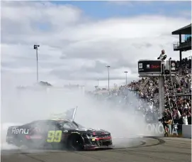  ?? (Chris Graythen/Getty Images) ?? Daniel Suarez, driver of the #99 Onx Homes/Renu Chevrolet, celebrates with a burnout after winning the Cup Series Toyota/Save Mart 350 at Sonoma Raceway Sunday.