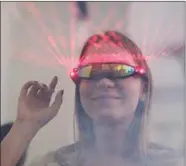  ?? ?? A Bitcoin enthusiast tries a pair of sunglasses that emits laser beams, which is part of the “laser eyes” trend among the cryptocurr­ency community, during the launch of Adopting Bitcoin: A Lightning Summit in El Salvador, in San Salvador, El Salvador on 16 November. REUTERS