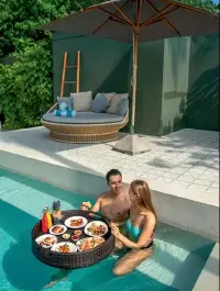  ??  ?? Wake up to a floating tray of breakfast delicacies in your pool. Left: 70 per cent of the island is a tropical jungle.