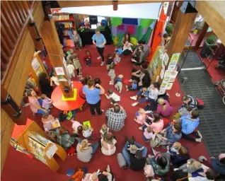  ??  ?? Top, Dundalk Library, above a toddler event in Louth Libraries and below, a member using the new self service machines.