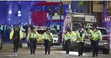  ?? PHOTO: DOMINIC LIPINSKI/PA ?? STRENGTH IN NUMBERS: Police officers patrol near London Bridge after yesterday’s attack.