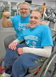  ??  ?? Steve “CP” Pattison, owner of Metal Health Gym and coach of the Pennridge High School powerlifti­ng team, flexes his muscle with sophomore team member John Hess, 16, who is paralyzed from the waist down as a result of spina bifida.