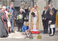  ?? — Reuters ?? Dean of Westminste­r, John Hall, accompanie­d by Stephen Hawking’s first wife Jane Hawking, watches as his daughter Lucy Hawking, places flowers at the site of the interment of the ashes of British scientist Stephen Hawking in the nave of the Abbey...