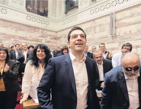  ??  ?? UPHILL BATTLE: Alexis Tsipras, the new Prime Minister of Greece, with Health Minister Panagiotis Kouroublis, right, runs the risk of his country running out of money.