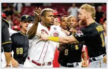  ?? ANDY LYONS / GETTY IMAGES ?? They couldn’t hold back Yasiel Puig and he kept trying to get to several Pirates and the melee lasted several minutes Tuesday night at Great American Ball Park.