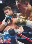  ??  ?? Gennady Golovkin throws a punch at Canelo Alvarez.