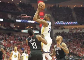  ?? TROY TAORMINA / USA TODAY SPORTS ?? Golden State forward Kevin Durant shoots over Houston’s James Harden and PJ Tucker on Monday. Durant had 37 points.