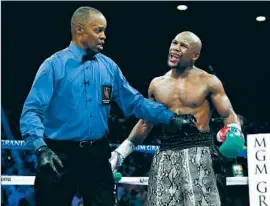  ?? Al Bello
Getty Images ?? KENNY BAYLESS, shown in September during Floyd Mayweather’s fight with Marcos Maidana, will be the referee for the Mayweather-Manny Pacquiao bout.