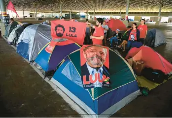  ?? SERGIO LIMA/GETTY-AFP ?? Returning leader in Brazil: Supporters of President-elect Luiz Inacio Lula da Silva camp Saturday at an exhibition hall in Brasilia, Brazil. Lula, 77, defeated far-right President Jair Bolsonaro in October, but many of Bolsonaro’s most die-hard supporters believed the election results to be fraudulent. Lula had been the president of Brazil from 2003 through 2010.