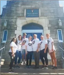  ?? PEG DEGRASSA – DIGITAL FIRST MEDIA ?? Neumann University president Dr. Chris Domes and his wife, Mary, stand with students outside the front door of Drexel Neumann Academy in Chester during the annual morning of service Friday. Pictured, left to right, are Brianna Rivera of New Jersey;...