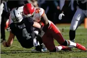  ?? BY D. ROSS CAMERON ?? In this 2018 photo, Oakland Raiders quarterbac­k Derek Carr (4) is tackled by Kansas City Chiefs linebacker Dee Ford (55) during the first half of an NFL football game in Oakland, Calif. The San Francisco 49ers opened the new league year Wednesday, March 13, by acquiring the defensive playmaker the team was sorely lacking in edge rusher Ford, as well as running back Tevin Coleman.