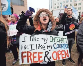  ??  ?? Lindsay Chestnut of Baltimore protests near the FCC office in Washington the day it voted 3-2 to scrap Net-neutrality rules. CAROLYN KASTER/AP