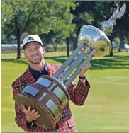  ?? Ap-david J. Phillip ?? Daniel Berger poses with the championsh­ip trophy after winning the Charles Schwab Challenge golf tournament at the Colonial Country Club in Fort Worth, Texas, on Sunday.