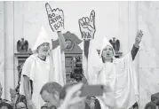  ?? Chip Somodevill­a / AFP / Getty Images ?? Protesters wearing white sheets shout at Sen. Jeff Sessions as he arrives for his confirmati­on hearing in the Russell Senate Office Building in Washington.