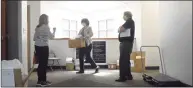  ?? H John Voorhees III / Hearst Connecticu­t Media ?? Mona LaBissonie­re, health educator/sanitarian, and Neil Lustig, right, director, Pomperaug District Department of Health distribute PPE to Maureen Sallee, left, of Dr Sallee dentist office, in the office in Southbury on April 7, 2020.