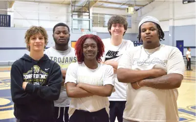  ?? (The Sentinel-Record/Donald Cross) ?? High Impact Movement volunteers, from left, Nicolas Haines, Johnavan Baker, Imani Honey, Benjamin Herrera, and Corliss Brewer stand to the side of the basketball court at the Champion Community Center last week.