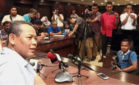  ??  ?? Stern warning: Aminuddin speaking to reporters at Wisma Negri.