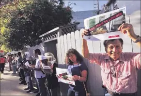  ??  ?? MANUEL MARQUINA joins activists, including labor groups and local residents, in a protest in Venice. Among their objections to vacation rentals: less housing for locals.